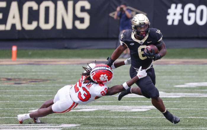 Wake Forest Demon Deacons running back Justice Ellison (6) runs past Clemson Tigers cornerback Toriano Pride (23) during the second half at Truist Field.
